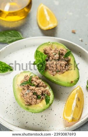 Avocado, tuna salad on plate. organic healthy products. vertical image. top view. copy space for text. Royalty-Free Stock Photo #2393087693