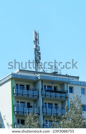 base station tower of a cellular network on the top of a residential building Royalty-Free Stock Photo #2393088755