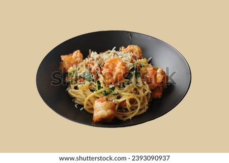 Picture of spaghetti with shrimp on a plate On a brown background, isolate