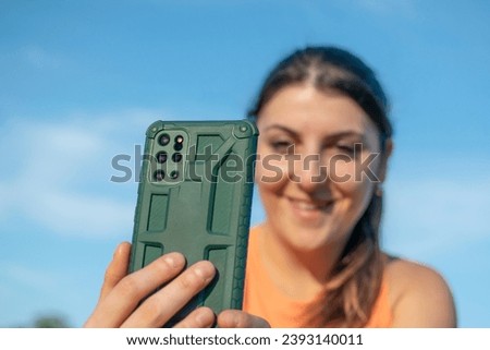 Cheerful Caucasian Young Woman using her phone in video call
