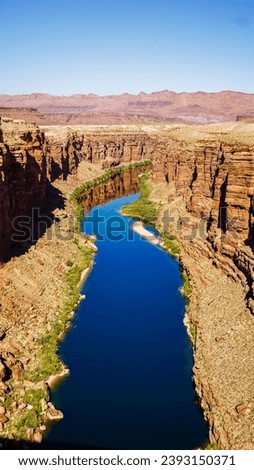 Views of the Navajo bridge on a clear day with the Colorado river below and condors on the bridge Royalty-Free Stock Photo #2393150371