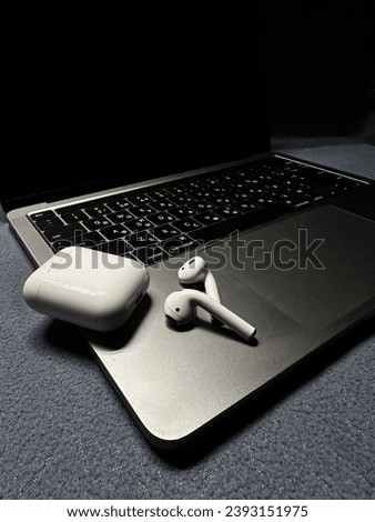A photo featuring three modern tech items: a laptop, a tablet, and headphones.