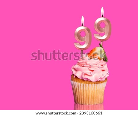 Birthday Cupcake With Candle Number 99 - On Hot Pink Background.