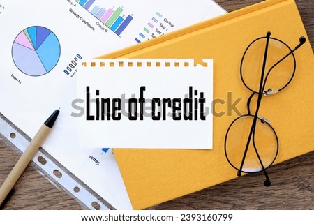 LINE OF CREDIT. text on the page on a yellow notepad.
