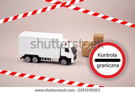 A white toy truck or van and a no-passing sign with the text Control Border of the Polish customs border.