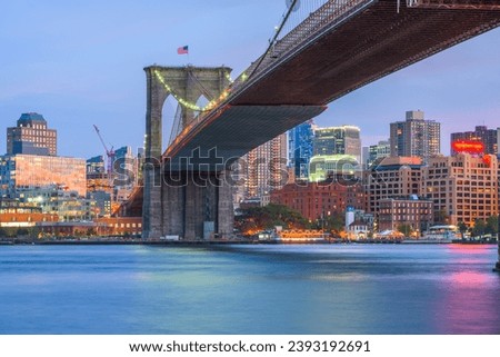 Brooklyn Bridge, New York City, USA spanning towards Brooklyn over the East River at dusk.