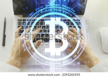 Double exposure of creative Bitcoin symbol hologram with hands typing on computer keyboard on background. Mining and blockchain concept