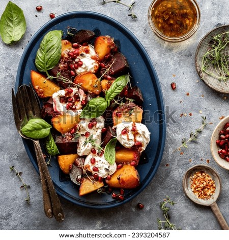 A platter of roasted beets with burrata cheese topped with herbs and pomegranate Royalty-Free Stock Photo #2393204587