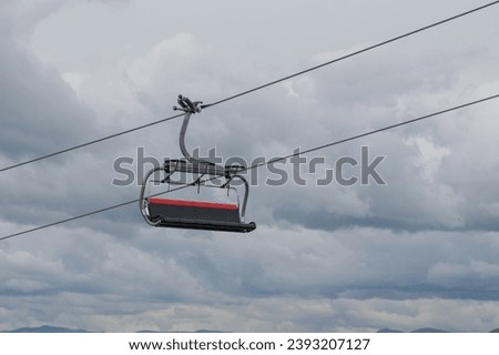 isolated chair of a chairlift at a winter sports area Royalty-Free Stock Photo #2393207127