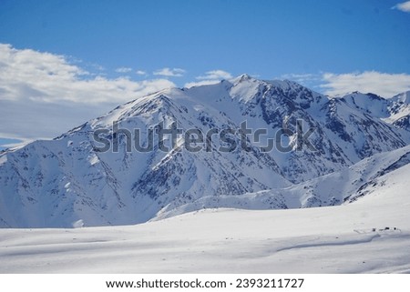 Scenic view of a snow-covered mountain on a beautiful winter day. Andes mountain range, Chile. Royalty-Free Stock Photo #2393211727