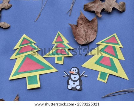 holiday themed arts and crafts for kids with colorful christmas trees and snowman (construction paper cut out with leaves) family activity for children during winter holidays greeting card, celebrate
