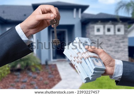 Man Handing a man Thousands of Dollars For Keys in Front of House