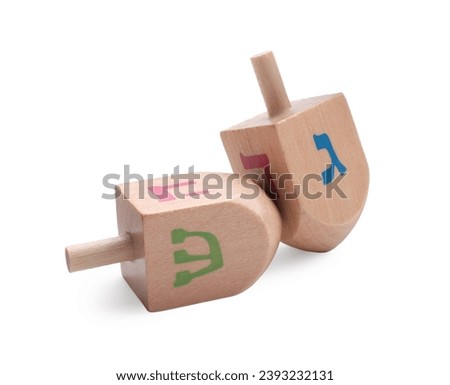 Wooden dreidels isolated on white. Traditional Hanukkah game Royalty-Free Stock Photo #2393232131
