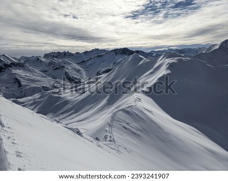 Backcountry skier riding from Girenspitz St.Antonien. Skitour in powder snow. Great deep snow freeride. Black White 