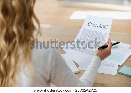 Businesswoman reading contract before signing. Making financial business deal, sale and purchase transaction. Concept of application form for mortgage, loan, buy or rent house. Important papers.