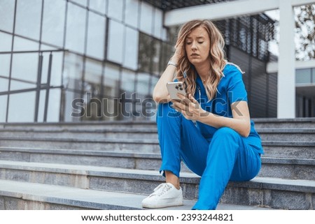 Shot of a female nurse looking stressed while sitting on a staircase. Female nurse sitting on the floor and looking distraught. She's deeply worried about one of her patients