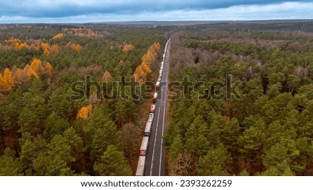 a queue of trucks waiting for border clearance at the road crossing between Poland and Ukraine Royalty-Free Stock Photo #2393262259