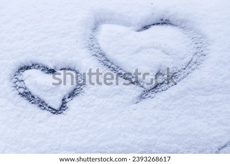 Images of a heart in the snow. Winter natural background.