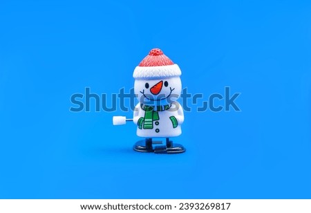 Toy snowman on a blue background. Christmas concept.