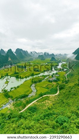 Aerial view of sunrise on mountain at Ngoc Con ward, Trung Khanh town, Cao Bang province, Vietnam with beautiful river, nature, green rice fields. Near Ban Gioc waterfall. Travel and landscape concept