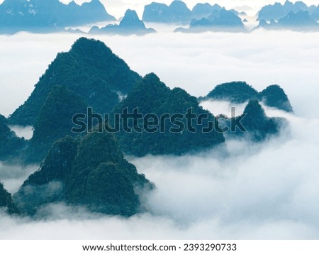 Aerial view landscape in Phong Nam valley in cinematic sunrise with fog, an extreme scenery landscape at Cao bang province, Vietnam with river, nature, green rice fields. Travel and landscape concept.