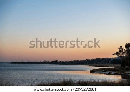 Sunset on Leschnault Estuary, calm water, mild sunset sky. Royalty-Free Stock Photo #2393292881