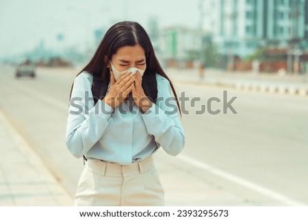 Asian Women wearing Protection Mask feels headaches and cough due to air pollution PM 2.5 Air pollution caused health problems. environmental pollution Royalty-Free Stock Photo #2393295673
