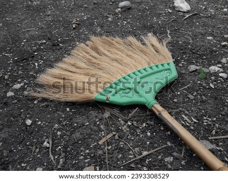 Traditional broom object on black ground background
