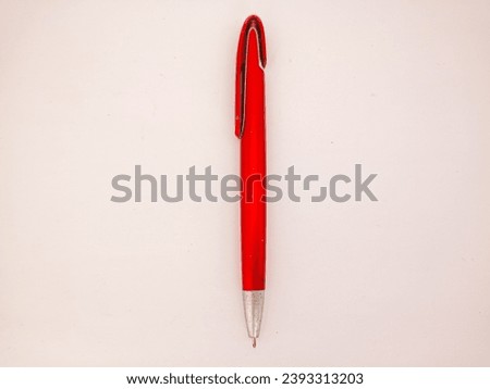 red ballpoint pen or red pen in the photo from above on a white background