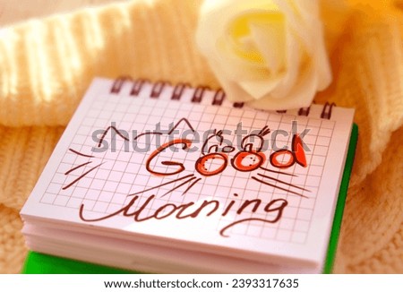 Text Good Morning on paper, notepad and rose flower. Motivation. Love. Atmospheric mood