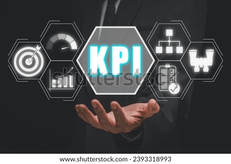 KPI, Key performance indicator business and industrial analysis concept, Busnessman hand holding KPI icon on virtual screen.