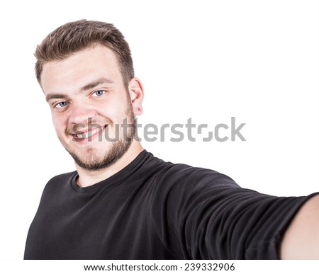 Happy young man taking a selfie photo. Isolated on white background