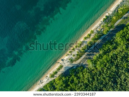 Aerial view of Rincon del Mar beach, Sucre, Colombia, showcasing the stunning green waters of the Caribbean Sea and the palm-lined shore