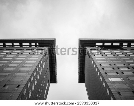 A striking image of two tall towers, their geometric shapes and symmetry creating a sense of order and balance. The abstract concept of the image is juxtaposed against its minimalist structure...