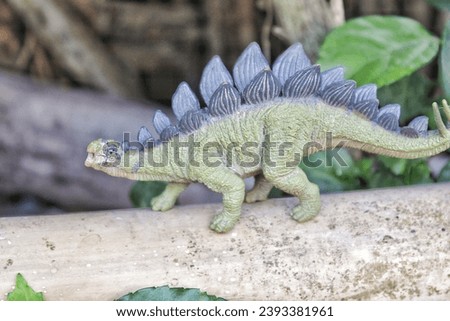 Stegosaurus dinosaur toy on nature background