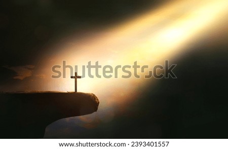 cross of jesus christ on sorrow darkness and bright light and rays background Royalty-Free Stock Photo #2393401557