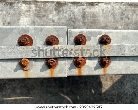 Closeup of rusted nuts cable tray