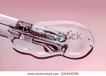 Liquid pipette serum pink gel on light berry colored mirror background Royalty-Free Stock Photo #2393430785