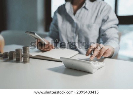Business owner is counting money and making notes in a financial book, Financier is verifying the income received from the client's investment, Accountant calculated how much money there was in total.