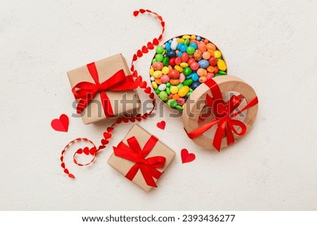 Valentine day composition: sweet candy, with gift boxes with bow and red felt hearts, photo template, background. Top View with copy space.