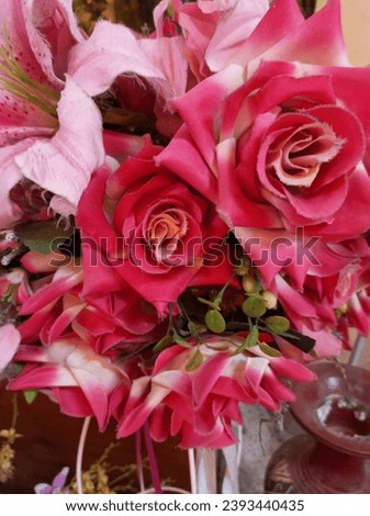 a bouquet of pink roses and other flowers the roses are a deep pink color with a hint of orange