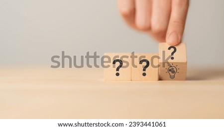 Question marks and light bulb symbolizing idea or solution. Problem solving skill, creativity, innovation, brainstorming, critical thinking and root cause analysis concept. Question, idea and answer. Royalty-Free Stock Photo #2393441061
