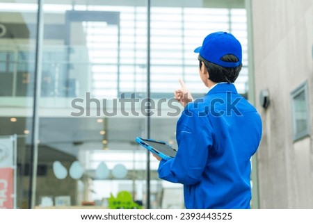 Asian worker inspecting a building. Building maintenance.