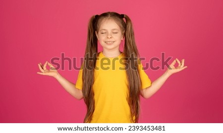 Zen. Relaxed Little Girl Meditating With Closed Eyes Over Pink Background, Calm Cute Female Child Practicing Yoga, Keeping Hands In Mudra Gesture While Posing In Studio, Copy Space
