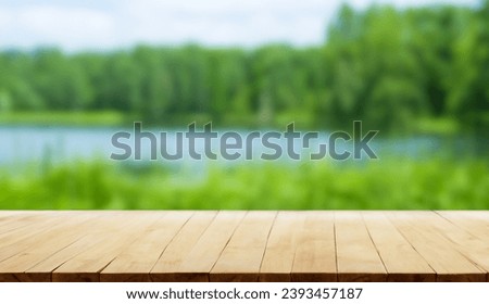  The empty wooden table top with blur lagoon background