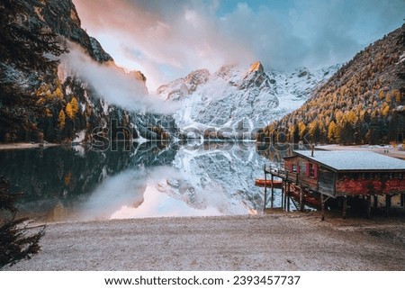 Great view of the mighty rock above peaceful alpine lake Braies (Pragser Wildsee). Location Dolomiti Alps, National park Fanes-Sennes-Braies, Italy, Europe. Photo wallpaper. The beauty of the Earth.
