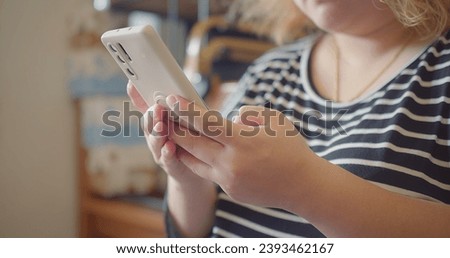 Close up Young woman hands holding smartphone using mobile application, e-commerce client, e-shopping touching scroll page app on mobile phone. Modern technology usage for fun