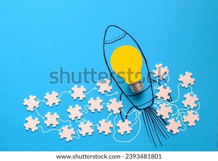 Business concept,teamwork makes the dream work,cooperation,innovation,human resources,recruitment,ideas with lightbulb,rocket and puzzle pieces,free copy space. Royalty-Free Stock Photo #2393481801