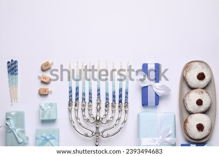 Flat lay composition with Hanukkah menorah and gift boxes on light background. Space for text