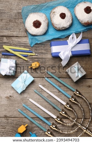 Flat lay composition with Hanukkah menorah and gift boxes on wooden table